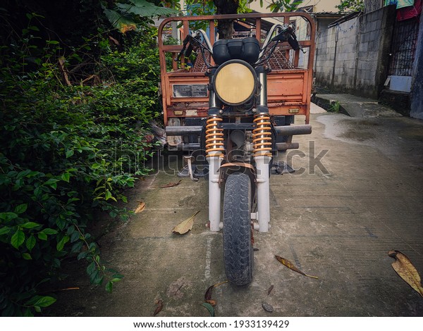 Bekasi\
indonesia ( 03-2021 ) front and side view of the cargo motorbike.\
front and side views of the three wheeled motorbike. Three wheeled\
cargo motorbike. three wheeled cargo\
motorcycle.