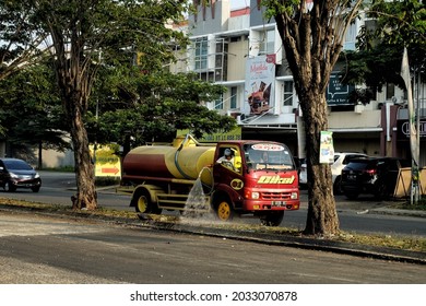 Bekasi Indonesia ( 08-2021 ) Officers Who Are Watering Plants Using A Water Tank Car