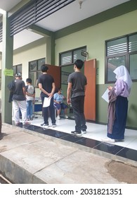 Bekasi, Indonesia, August 20, 2021: Asian Junior High School Student In Medical Face Mask Queuing At School For Getting Vaccinated Against Coronavirus From Doctor Or Nurse.