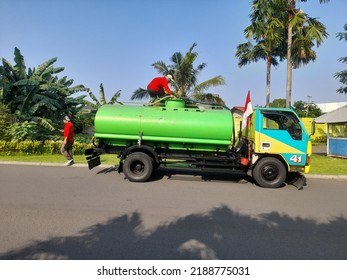 Bekasi, Indonesia - August 2022 : Clean Water Truck Side View From A Distance. Background Concept Of Transport, Transportation, Work, Worker, Industry, Industrial,vehicle,park,outdoor,nature, Natural