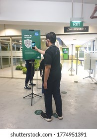 Bekasi, Indonesia, July 10, 2020: People Using Smartphone Scan QR Code Register Their Identity Before Entry The Store Or The Mall Building In Order To Prevent Covid-19. New Normal Lifestyle Concept. 