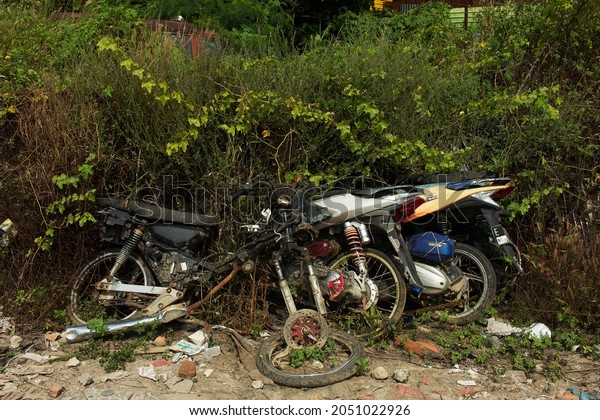 BEKASI, INDONESIA - JULY\
14, 2020: A pile of abandoned motorcycles in Bekasi, West Java,\
Indonesia.