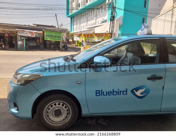 bekasi, indonesia - june 2022 : blue taxi\
car side view on the highway. background concept of transport,\
transportation, public transportation, public facilities, vehicle,\
destination,\
meter,passenger