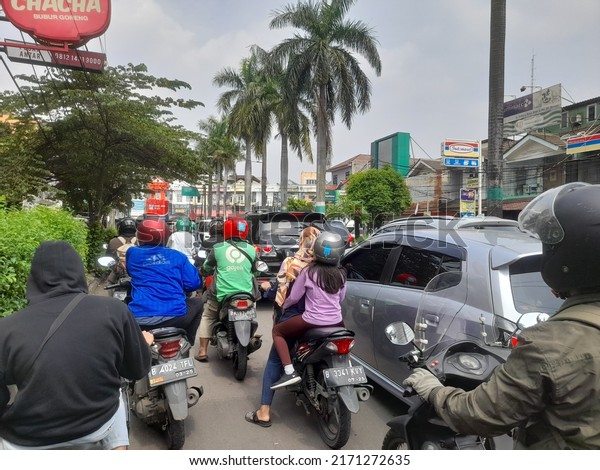 Bekasi, indonesia : june 2022 : traffic\
jams on highways in urban areas which are dominated by motorbikes\
and cars. background concept of transport, transportation,\
motorcycle,motorbike,\
people,person