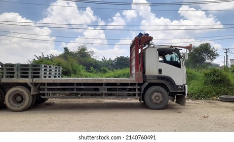 Bekasi, Indonesia - March 2022 : Cargo Truck Side View Against Blue Sky And White Clouds Background.concept Background Industry,industrial,transport, Transportation,work,worker,urban,city,truck Driver