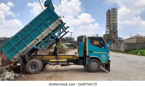 Bekasi, Indonesia - March 2022 : Sand And Dirt Truck Side View On Highway On Blue Sky Background. Background Concept Of Transport, Transportation, Industry, Industrial, Work, Worker, Urban, City