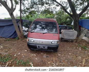 Bekasi, Indonesia - May 2022 : Mitsubishi Colt Car Front View In The Paddy Field. Background Transport Concept, Transportation, Lifestyle, Vintage, Antique, Retro, Old, Vehicle, Automotive, Industry