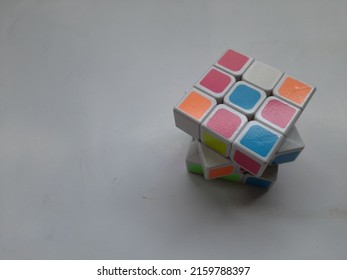 Bekasi, Indonesia - May 2022 : Rubik's Educational Game Seen From Above On A White Background. Background Puzzle Concept, Education, Cube, Hand Cube,train Intelligence,lifestyle,hobby,hobbies,symbol