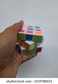 Bekasi, Indonesia - May 2022 : Rubiks Educational Game Seen From Above On A White Background. Background Puzzle Concept, Education, Cube, Hand Cube,train Intelligence,lifestyle,hobby,hobbies,symbol