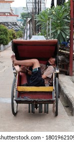 Bekasi, Indonesia - Mei 02 2020 : Man Asleep In A Rickshaw