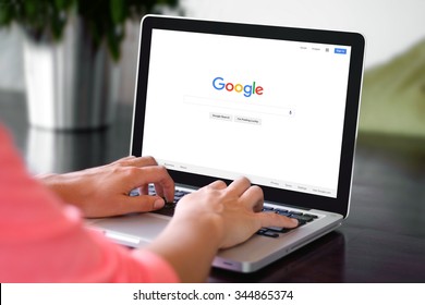 BEKASI, INDONESIA - NOVEMBER 29, 2015: A woman is typing on Google search engine from a laptop. Google is the biggest Internet search engine in the world.