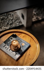 Bekasi, Indonesia - September 20th 2022. Mini Cup Of Hot Cappuccino Coffee With Latte Art On Wooden Pallet On Round Wooden Table Inside Cafe. High Angle View. Piccolo Coffee Brewing