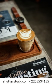 Bekasi, Indonesia - September 20th 2022. High Angle View Of Mini Glass Of Hot Cappuccino Coffee With Latte Art On Wooden Pallet On Concrete Bench Inside Cafe. Piccolo Coffee Brewing