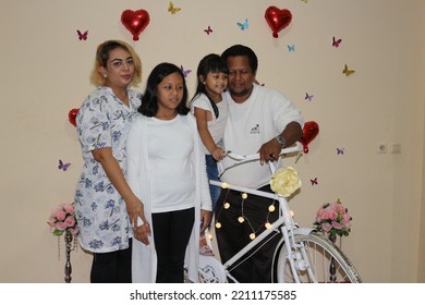 Bekasi West Java, Indonesia-May 12, 2019 : A Happy Family Wearing All White Uniforms Smiling Happily For The Camera