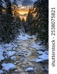 Bela river near Podbanske in winter with snow at sunset in Slovakia