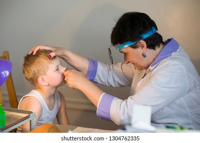 Belarus City Dobrush July 12, 2018. Children's Central Hospital. Child Otolaryngologist Examines The Patient. A Doctor Treats A Sick Nose To A Child. The Boy At The Hospital Admission