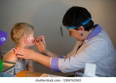 Belarus City Dobrush July 12, 2018. Children's Central Hospital. Child Otolaryngologist Examines The Patient. The Doctor Treats A Sore Ear To A Child. The Boy At The Hospital Admission