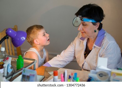 Belarus City Dobrush July 12, 2018. Children's Central Hospital. Child Otolaryngologist Examines The Patient. The Doctor Treats A Sore Throat For A Child. The Boy At The Hospital Admission