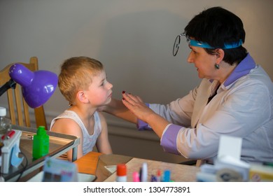 Belarus City Dobrush July 12, 2018. Children's Central Hospital. Child Otolaryngologist Examines The Patient. The Doctor Treats A Sore Throat For A Child. The Boy At The Hospital Admission