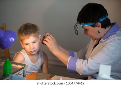 Belarus City Dobrush July 12, 2018. Children's Central Hospital. Child Otolaryngologist Examines The Patient. The Doctor Treats A Sore Ear To A Child. The Boy At The Hospital Admission