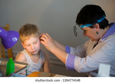 Belarus City Dobrush July 12, 2018. Children's Central Hospital. Child Otolaryngologist Examines The Patient. The Doctor Treats A Sore Ear To A Child. The Boy At The Hospital Admission