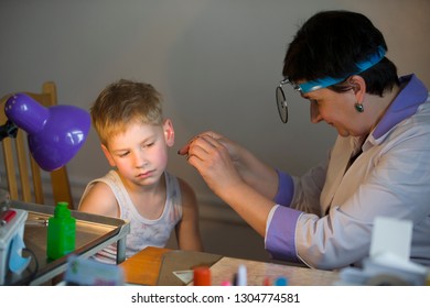 Belarus City Dobrush July 12, 2018. Children's Central Hospital. Child Otolaryngologist Examines The Patient. The Doctor Treats A Sore Ear To A Child. The Boy At The Hospital Admission