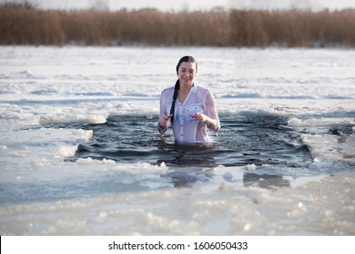 Belarus, the city of Gomel, January 19, 2017. Feast of the baptism of Jesus. Orthodox rite bathing in the ice hole. A woman bathes in ice water.