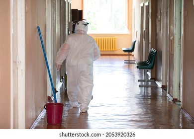 Belarus, The City Of Gomil May 31, 2021 Regional Hospital. A Cleaning Lady In A Protective Suit During A Coronavirus Infection Stands In A Hospital Corridor.