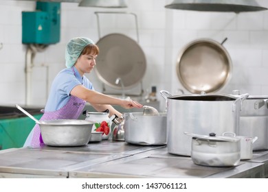 Belarus, Gomel, June 2, 2017.Industrial Kitchen In The Hospital. Cook Prepares Food. Cook With Large Pans And A Ladle. Kitchen Worker With A Ladle. Worker Dining.