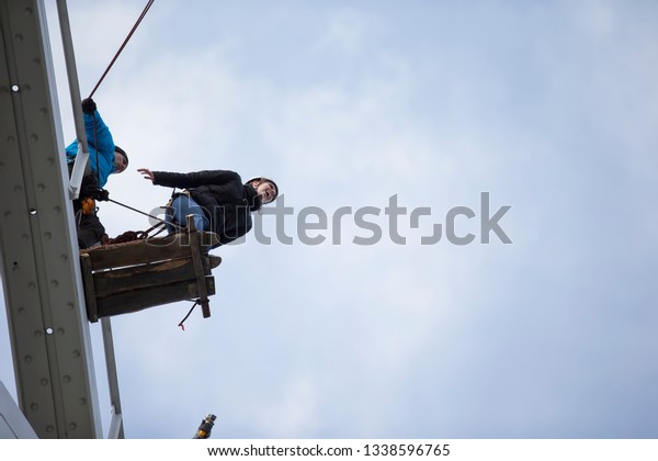 Belarus, Gomel, March 08, 2019. Jumping from the\
bridge to the rope.Ropejumping.Dangerous hobbies.Woman jumping down\
from a great height