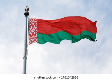 BELARUS, MINSK. JULY 2, 2020. State flags of the Republic of Belarus are waving in the wind on a flagpoles on the State Flag and Emblem Square. 
