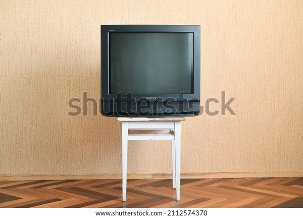 Belarus, Minsk - June 3, 2019: Sony trinitron\
kv-21m3 with green screen. Antique television on a wooden antique\
cabinet, old design in the house.\

