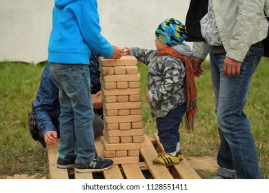 Belarus, Minsk, June 30,2018: Dad With A Child Plays Jenga Outdoor