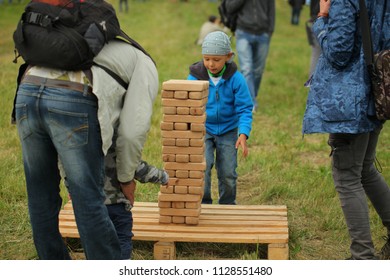 Belarus, Minsk, June 30,2018: Dad With A Child Plays Jenga Outdoor