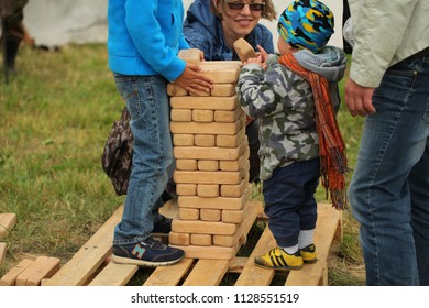 Belarus, Minsk, June 30,2018: Dad With A Child Plays Jenga Outdoor