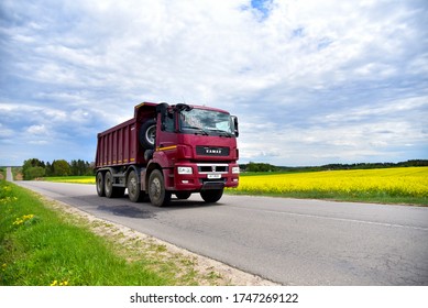 BELARUS, MINSK REGION - MAY 27, 2020: Tipper dump truck KAMAZ-65801-002-68(Т5) 8х4  transported sand from the quarry on driving along highway. Modern Heavy Duty Dump Truck