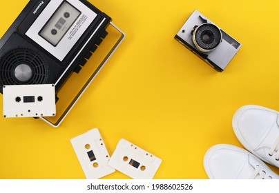 Belarus, Minsk-08.05.2021:Old film camera Zorki-10 released 1975, shooting on a standard 35mm film. Tape Recorder RQ-306S R-Player Panasonic 1970s on a yellow background.