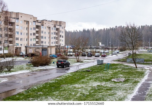 BELARUS, NOVOPOLOTSK - APRIL 25, 2020: Cars in yard,\
green grass and snow