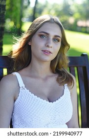 Belarus Woman In White Dress Sitting On Wooden Swings