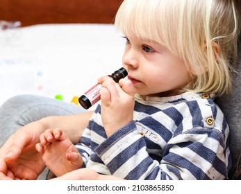 Belarus,minsk,2021. A Little Blond Boy Himself Smells A Rollerball With DoTerra Therapeutic Essential Oil From A Children's Set For Good Health