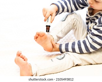 Belarus,minsk,2021. A Little Blond Boy Smears His Heels With A Rollerball With DoTerra Therapeutic Essential Oil From A Children's Set For Good Health