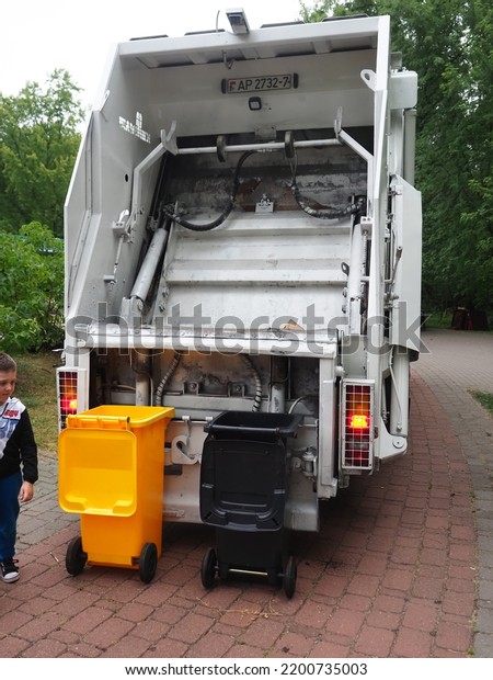 Belarus,Minsk,2022. Garbage truck upload trash\
plastic box