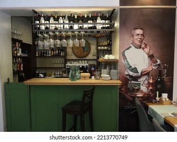 Belarus,Minsk,2022. Interior Of An Italian Cafe Restaurant Da Claudio. Bar Counter And Wall Painting With A Portrait Of The Chef. 