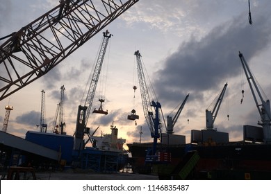 Belawan Port, Indonesia-June 2018: The Silhouette Of Cranes And Mechanical Tools At The Port Of Belawan To Support The Logistic Process At The Port.