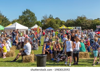 Belbroughton, UK, September 21, 2019 - Adults and children socialise and enjoy the weather, surrounded by stalls of local food and craft producers during Belbroughton Scarecrow festival.. 