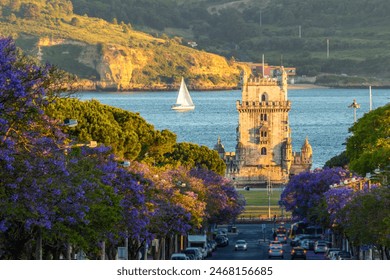 Belem Tower, Jacaranda Blooming Purple Blue Trees and Sailboat on Sunny Evening. Golden Hour. Lisbon, Portugal. - Powered by Shutterstock