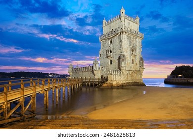 Belem Tower or Tower of St Vincent - famous tourist landmark of Lisboa and tourism attraction - on the bank of the Tagus River (Tejo) after sunset in dusk twilight with dramatic sky. Lisbon, Portugal - Powered by Shutterstock