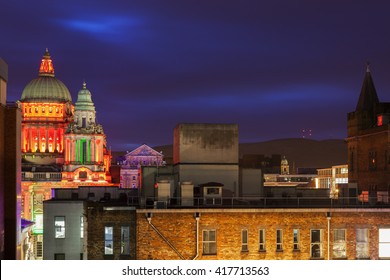 Belfast architecture with illuminated City Hall and Mt. Divis. Belfast, Northern Ireland, United Kingdom.