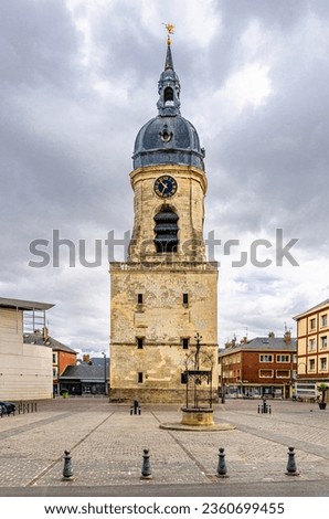 Belfry of Amiens beffroi d'Amiens bell tower stone building with clock and spire and stone well on empty square in old historical city centre, Somme department, Hauts-de-France Region, France