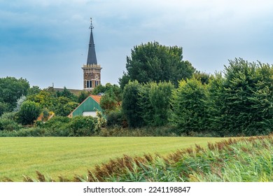 Belfry of the St. Bonifatiuskerk church in the village of Cornwerd surrounded by farmland in the province of Friesland, Netherlands - Shutterstock ID 2241198847